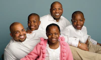 Family of five with two fathers posed in family portrait