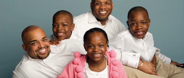 Family of five with two fathers posed in family portrait