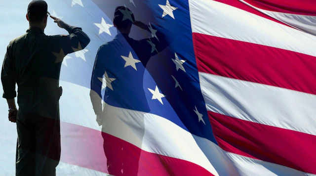 American flag with the silhouette of a solider saluting in front