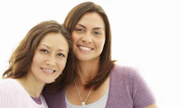 Two white women embracing.