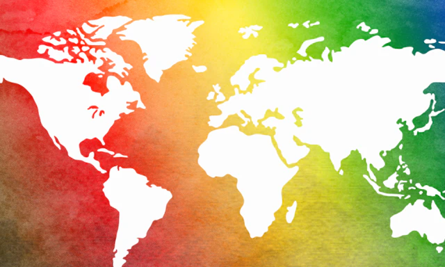 Map of the world with land masses in white on a rainbow background.