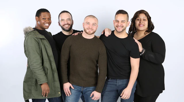 Diverse group of five people standing together