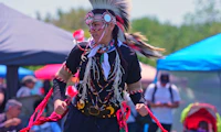 Person dancing in traditional Indigenous dress