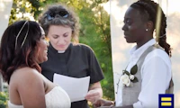 Two partners getting married outdoors with a female priest