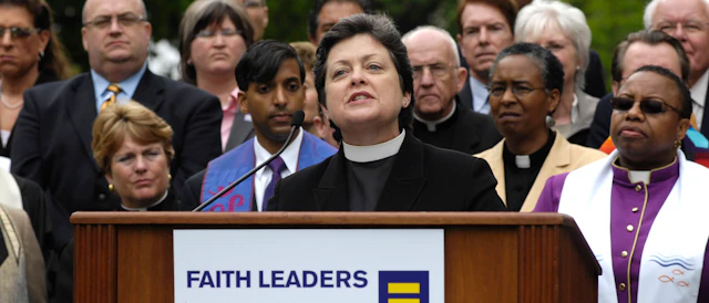 Group photo of different faith leaders with one speaking at a podium with a sign that says faith leaders and the HRC equality logo.
