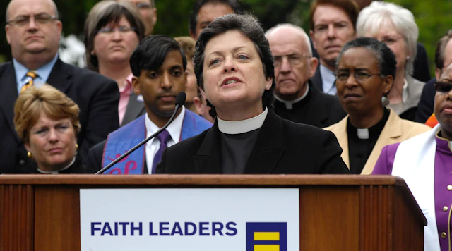 Group photo of different faith leaders with one speaking at a podium with a sign that says faith leaders and the HRC equality logo.