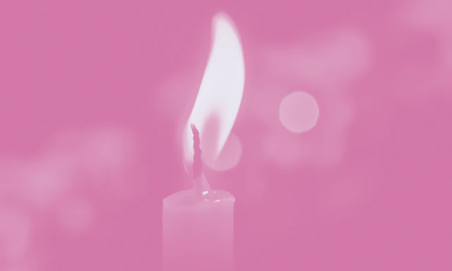 Lit candle with a pink color treatment