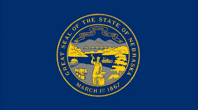 Nebraska state flag with text that reads "GREAT SEAL OF THE STATE OF NEBRASKA - MARCH 1ST, 1867" and the state motto "EQUALITY BEFORE THE LAW"