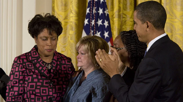 Group of three women with President Obama
